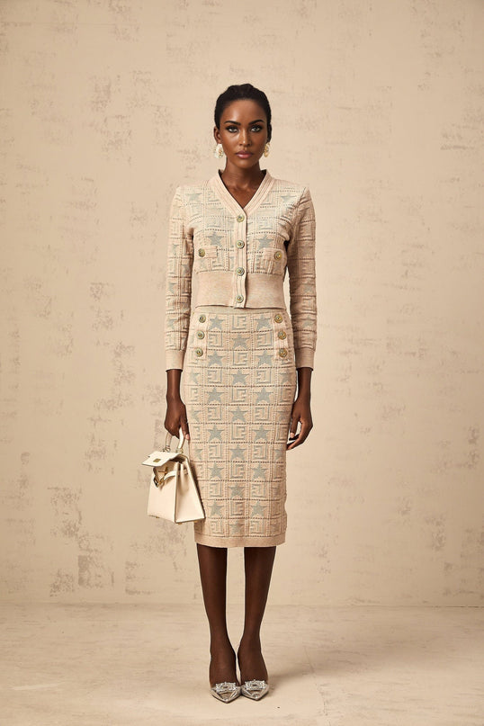 Woman wearing khaki cardigan and skirt set with star pattern crochet knit design Leonie matching outfit