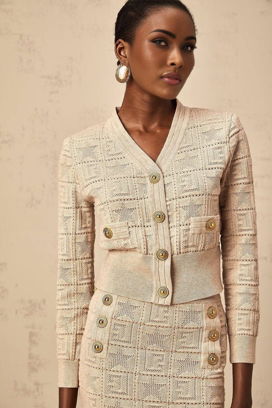 Woman wearing khaki cardigan and skirt set with star pattern crochet knit design Leonie matching outfit