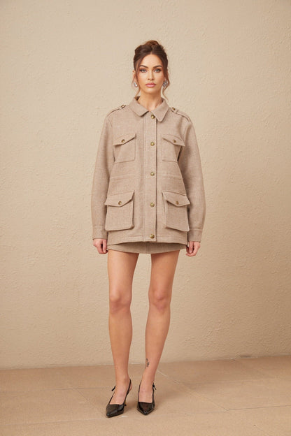 Woman wearing khaki wool twill jacket with matching culottes standing in neutral pose against plain background