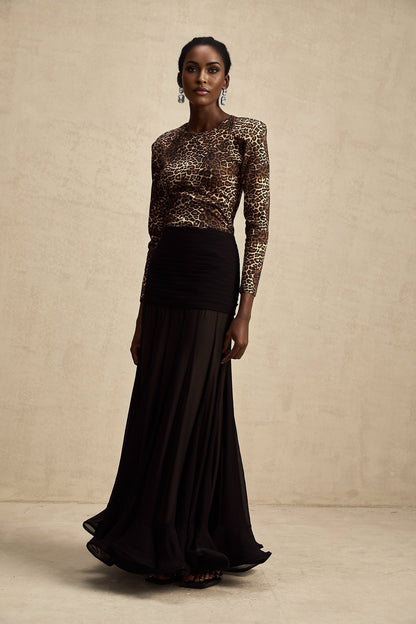 Woman wearing leopard print bodysuit with long sleeves and high neck