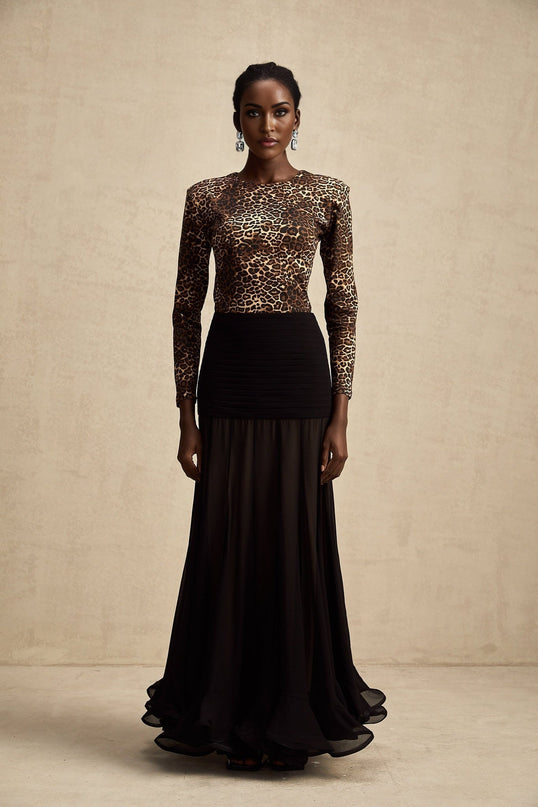 Woman wearing leopard print bodysuit with long sleeves and high neckline