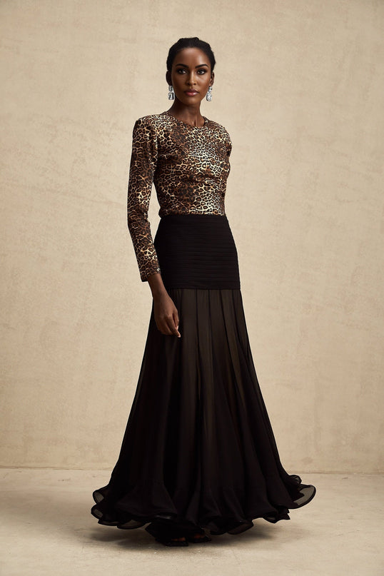 Woman wearing leopard print bodysuit with long sleeves and high neckline