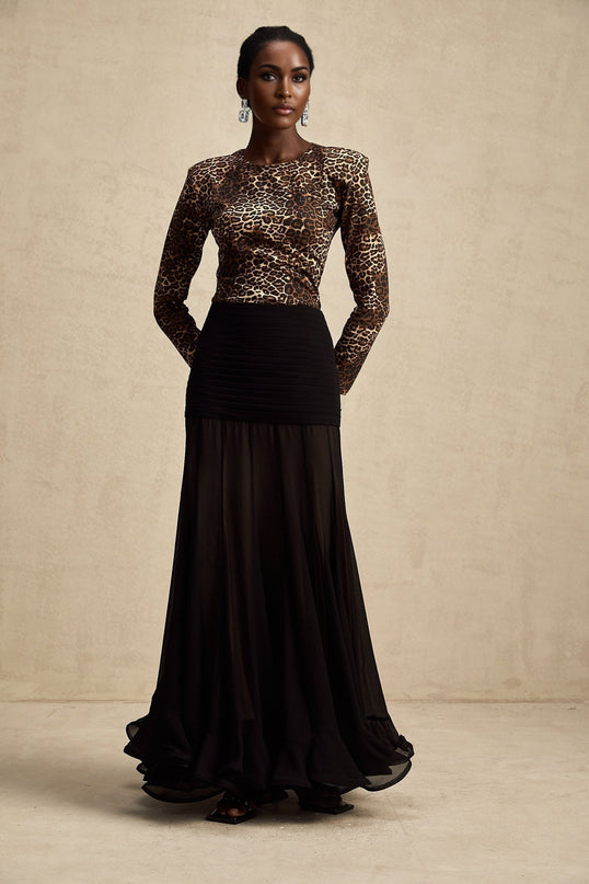 Woman wearing leopard print bodysuit with long sleeves and high neckline