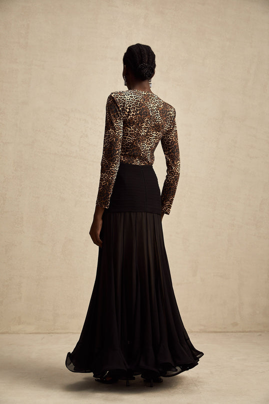 Woman wearing leopard print bodysuit with long sleeves and scoop neckline