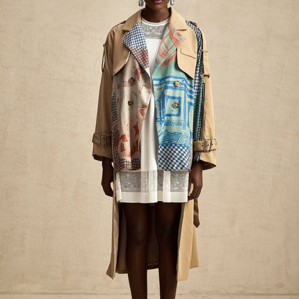 Woman wearing long belted trench coat with contrasting color print design and Josephine style details