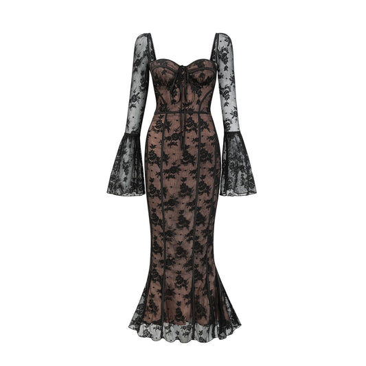 Woman wearing long black flared lace maxi dress with fitted bodice and flowing skirt