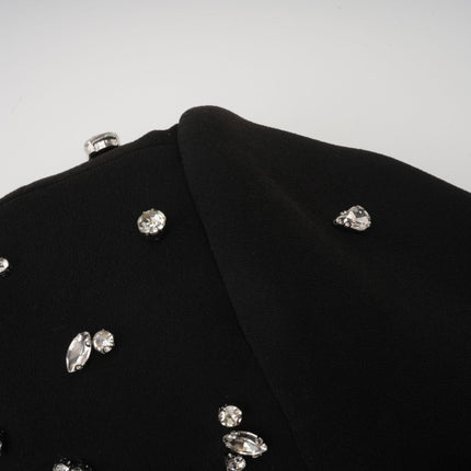 Woman wearing long black formal dress with crystal embellishments