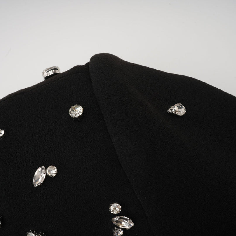 Woman wearing long black formal dress with crystal embellishments