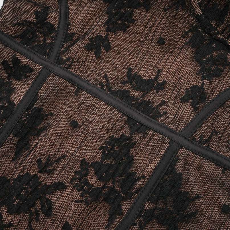 Woman wearing long black lace maxi dress with flared skirt and fitted bodice