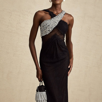 Woman wearing long black maxi dress with crossover bodice and crystal embellishments