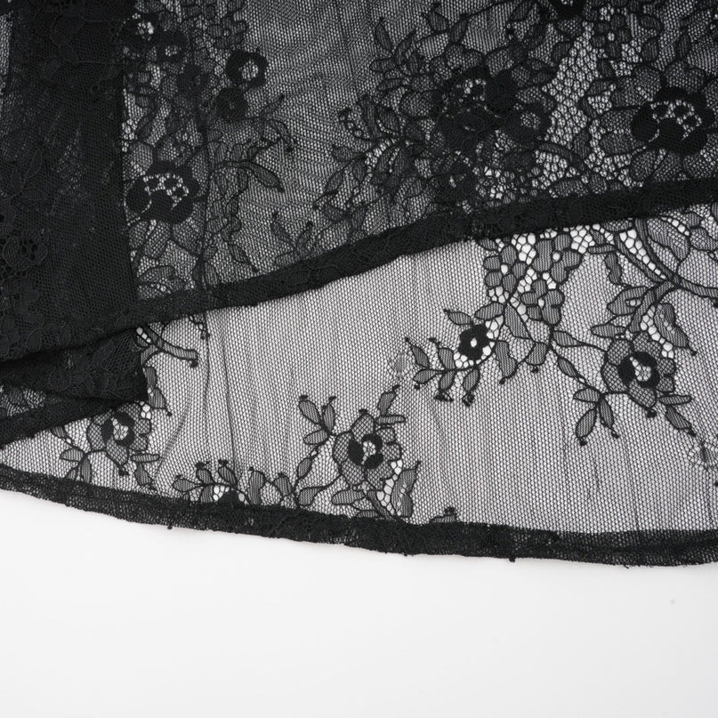 Woman wearing long black maxi dress with crystal embellishments and crossover design