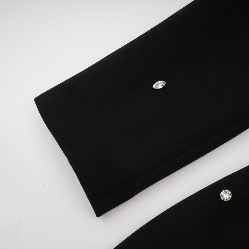 Woman wearing long black maxi dress with crystal embellishments elegant evening gown full length view