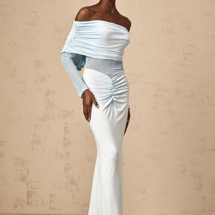 Woman wearing long blue offshoulder dress with ruched details and flowing maxi skirt