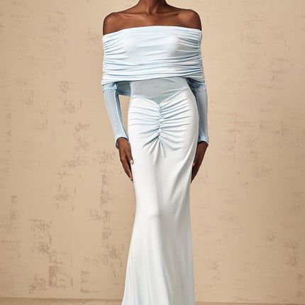 Woman wearing long blue offshoulder dress with ruched details and flowing maxi skirt