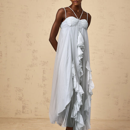 Woman wearing long blue tulle maxi dress with layered ruffles and tiered skirt