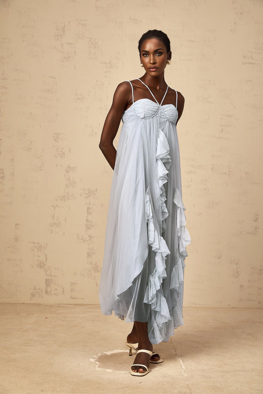 Woman wearing long blue tulle maxi dress with layered ruffles and tiered skirt