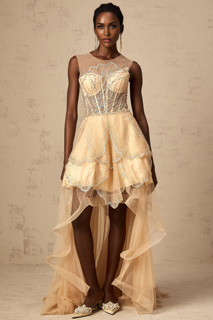 Woman wearing long champagne colored gown with daisy embellishments and high low hemline