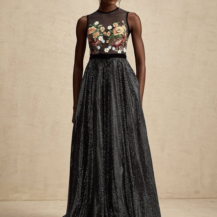 Woman wearing long floral embroidered maxi dress with white background