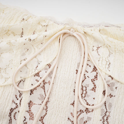 Woman wearing long floral lace maxi dress with train in neutral colors