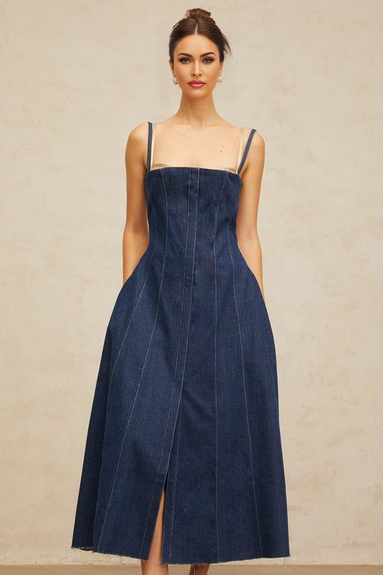 Woman wearing long indigo blue denim dress with panels and midi length