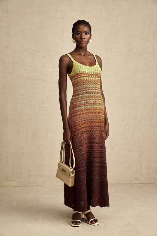 Woman wearing long knitted maxi dress with gradient color pattern named Audrey