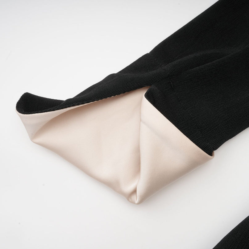 Woman wearing long maxi dress with contrasting colors and bow detail at vneck