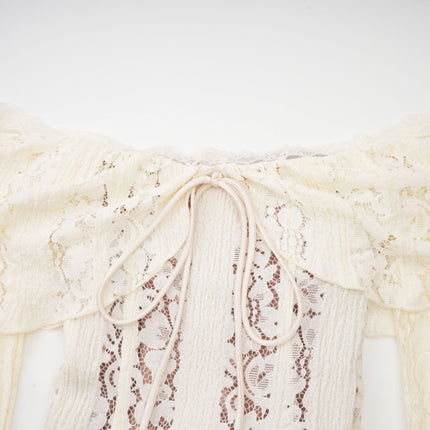 Woman wearing long neutral colored floral lace maxi dress with train design