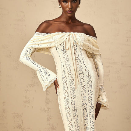 Woman wearing long neutral colored floral lace maxi dress with train design