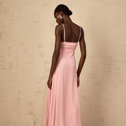 Woman wearing long pink maxi dress with 3D petal tulle details flowing skirt and sleeveless bodice