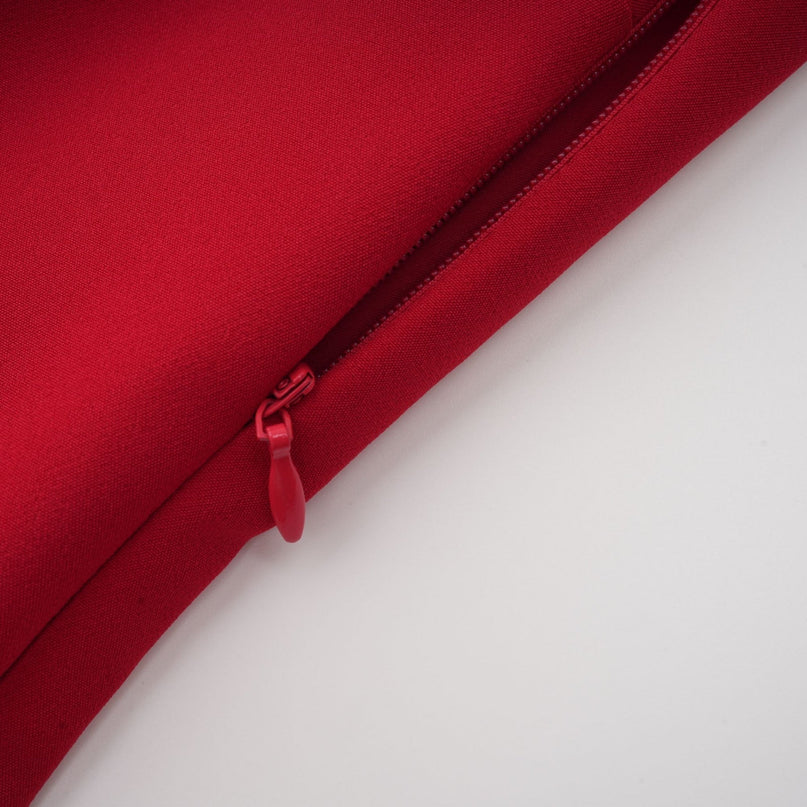 Woman wearing long red pleated maxi dress with high slit for Valentines Day