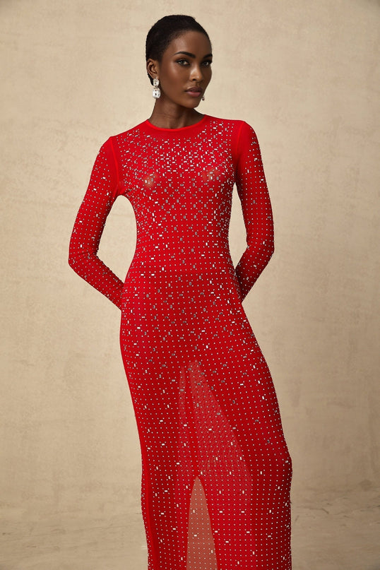 Woman wearing long red tulle dress with rhinestone embellishments and flowy skirt