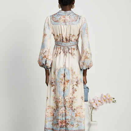 Woman wearing long sleeve floral print bohemian style dress with flowing skirt and cinched waist