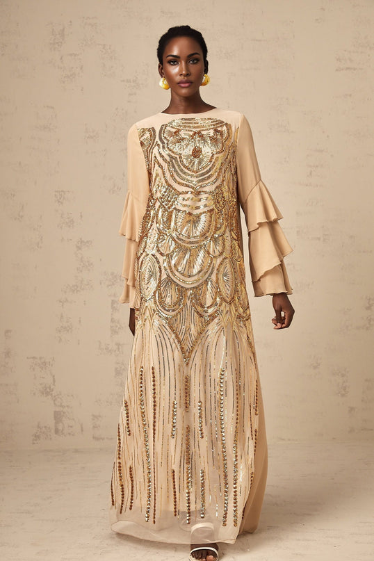 Woman wearing long sparkly tulle dress with ruffled sleeves and sequin details