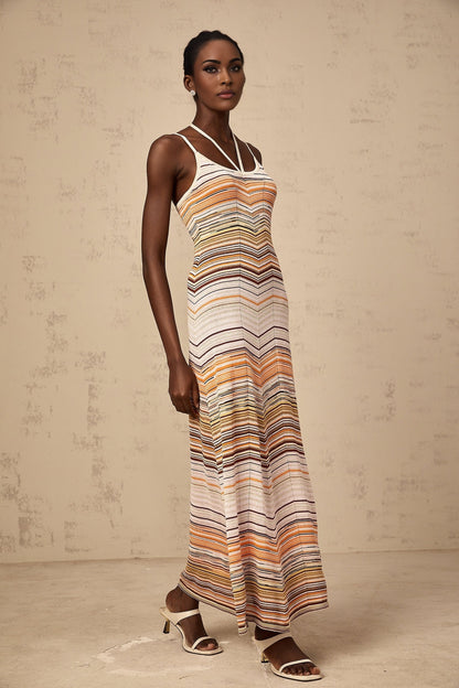 Woman wearing long striped knit maxi dress in multiple colors by Chloe