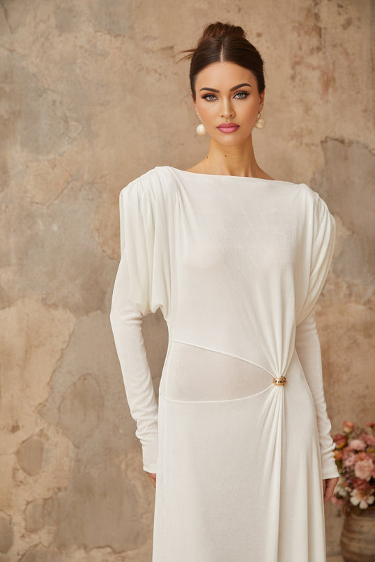 Woman wearing long white maxi dress with draped and shirred details flowing fabric elegant design