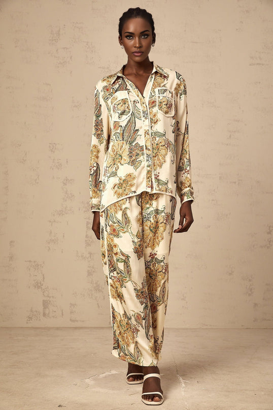 Woman wearing matching floral print shirt and trousers in neutral colors Agnès set
