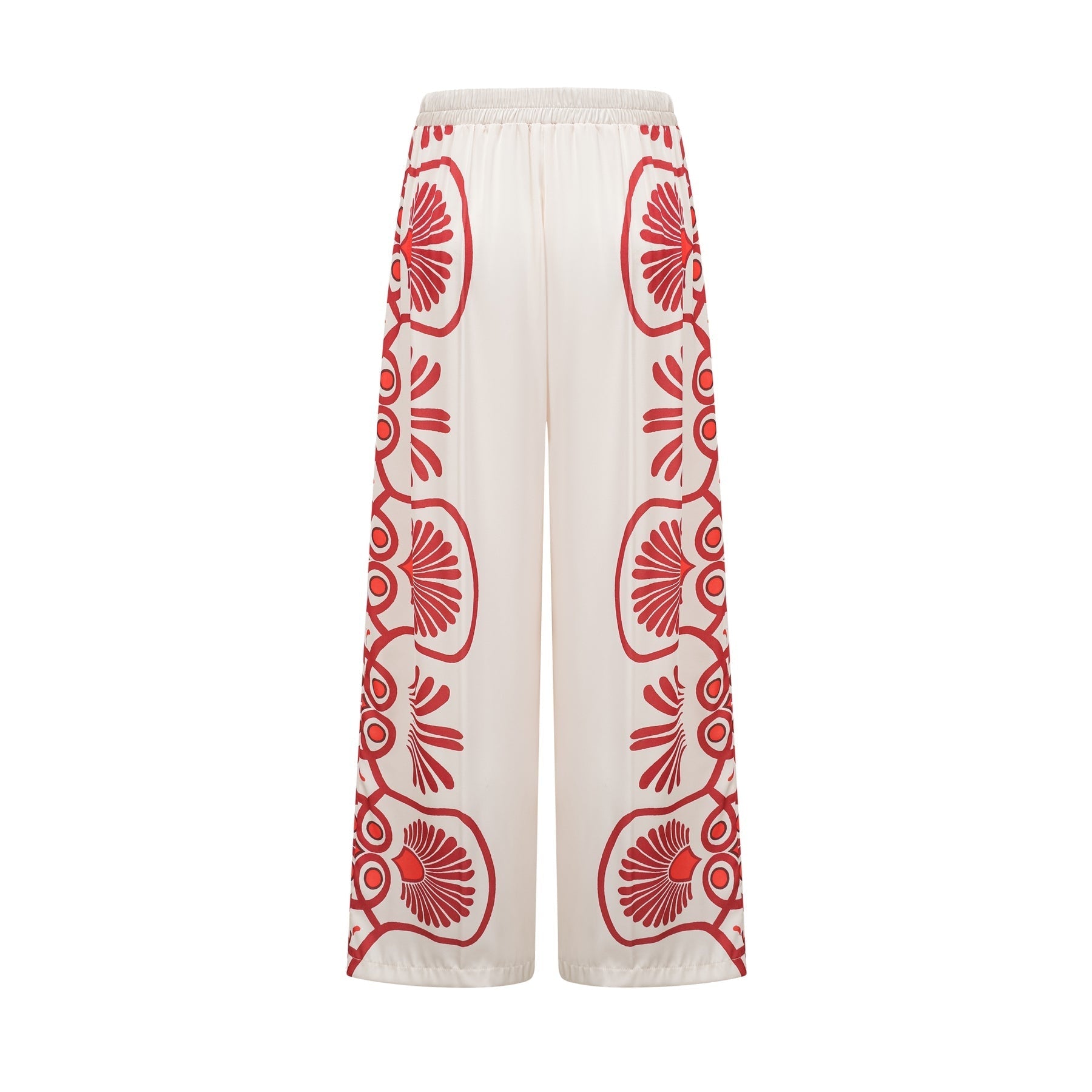 Woman wearing matching floral print shirt and trousers set in vibrant colors with Amaranta design