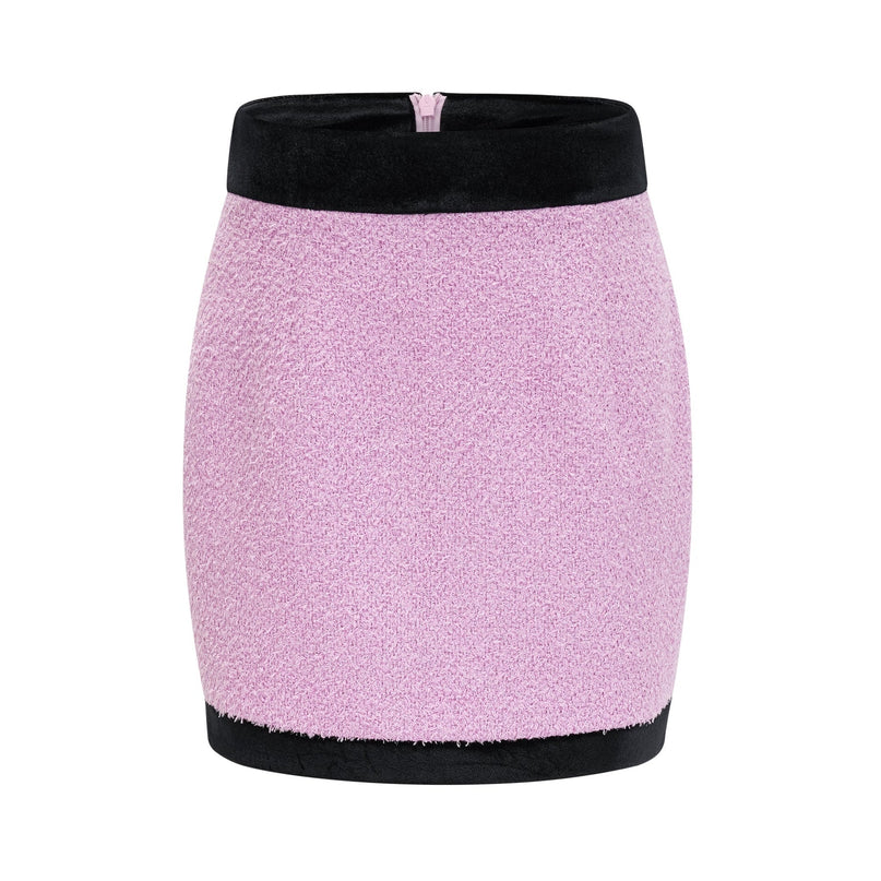 Woman wearing matching navy blue blazer and skirt set Professional office attire