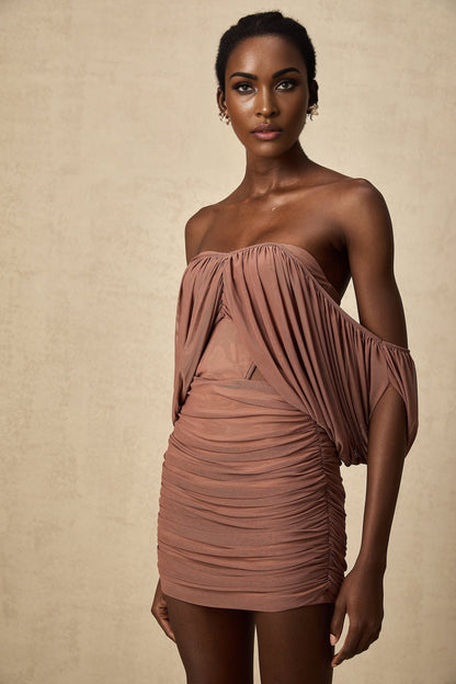 Woman wearing matching off shoulder bodysuit and skirt set in light color fabric