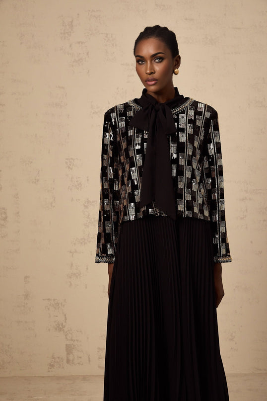 Woman wearing matching sequined cardigan and dress set in checked pattern named Eva