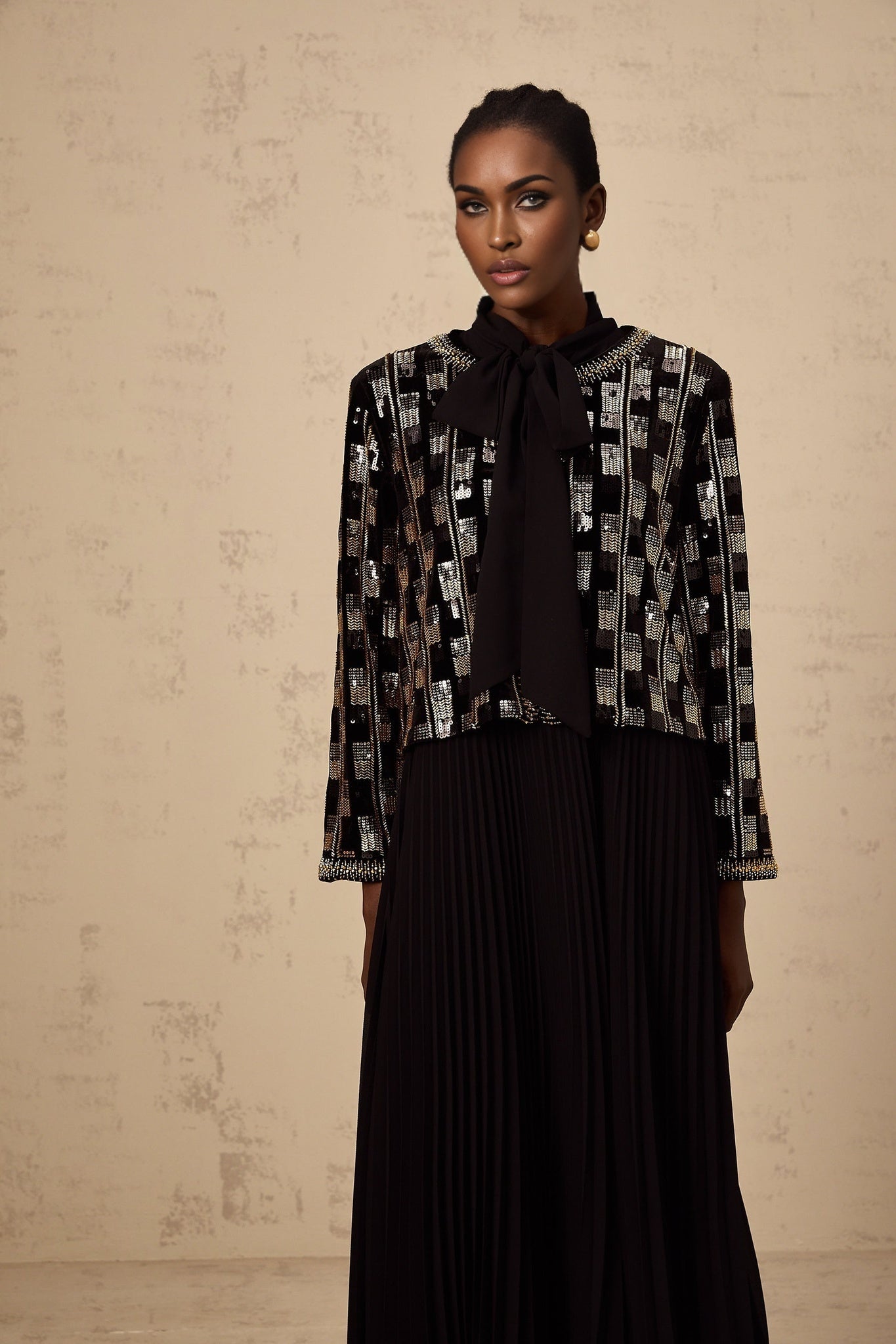 Woman wearing matching sequined cardigan and dress set in checked pattern named Eva