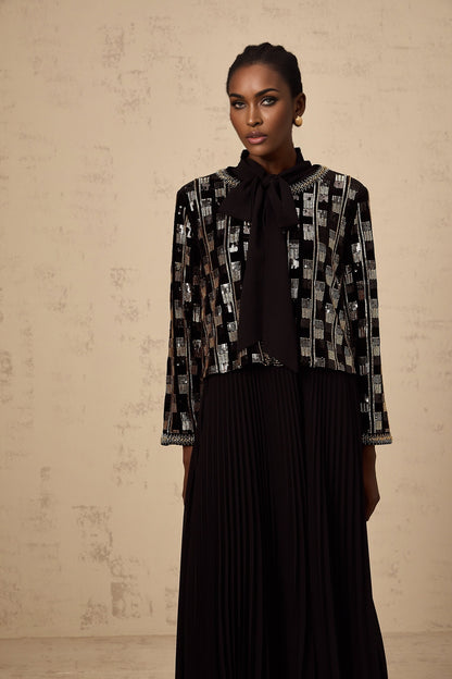 Woman wearing matching sequined cardigan and dress set in checked pattern named Eva