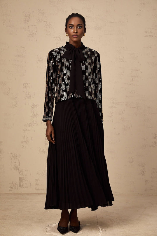 Woman wearing matching sequined cardigan and dress set in checkered pattern