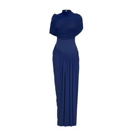 Woman wearing navy blue asymmetric pleated maxi dress with long flowing skirt and one shoulder design