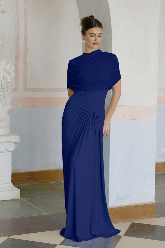 Woman wearing navy blue asymmetric pleated maxi dress with long flowing skirt