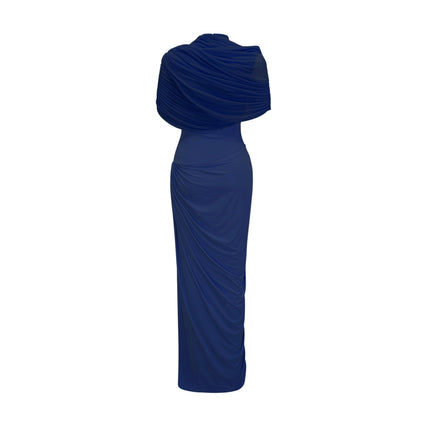 Woman wearing navy blue asymmetric pleated maxi dress with long sleeves and flowy skirt