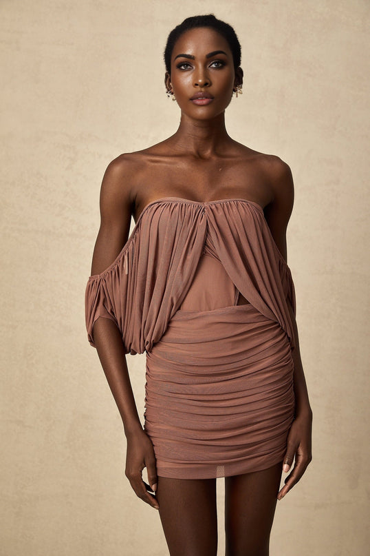 Woman wearing offshoulder bodysuit and matching skirt set in Zohra design