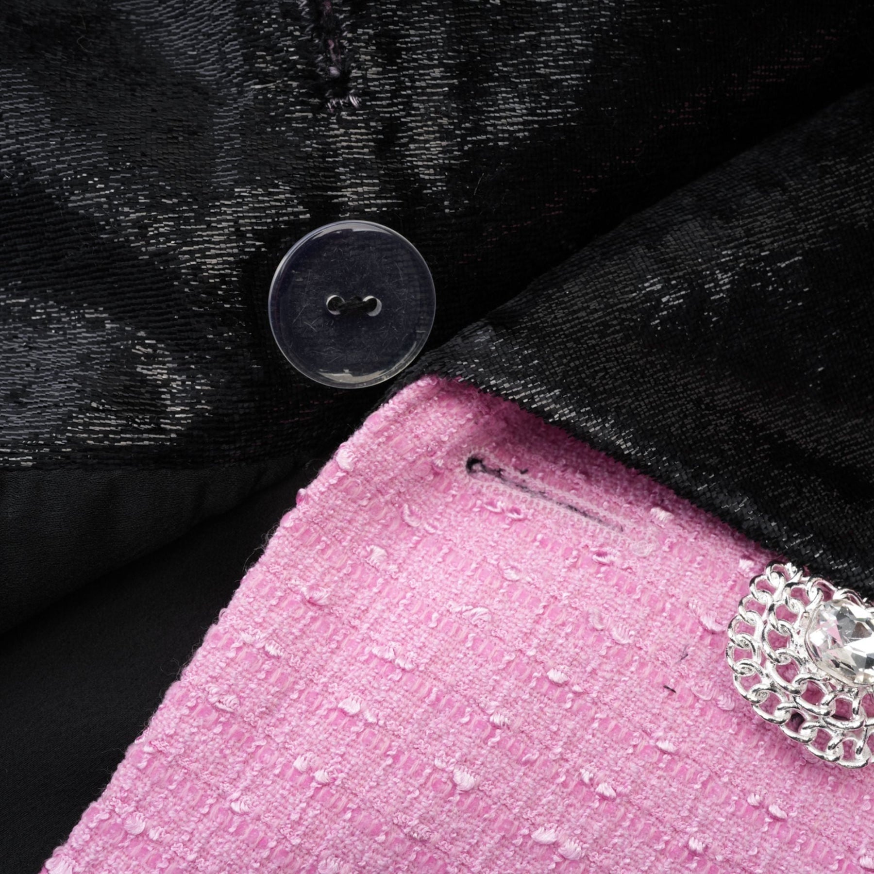 Pink jacket with Vshaped collar fulllength sleeves front button closures and fitted waist design