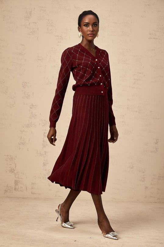 Woman wearing red cardigan and matching skirt with argyle pattern and embellishments Laurine knit set