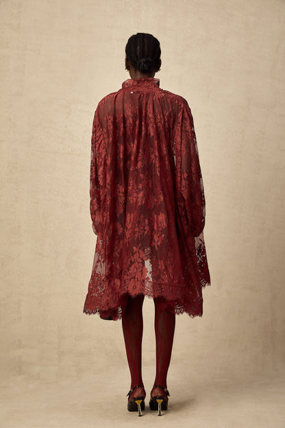 Woman wearing red floral lace tights with cutout pattern on legs